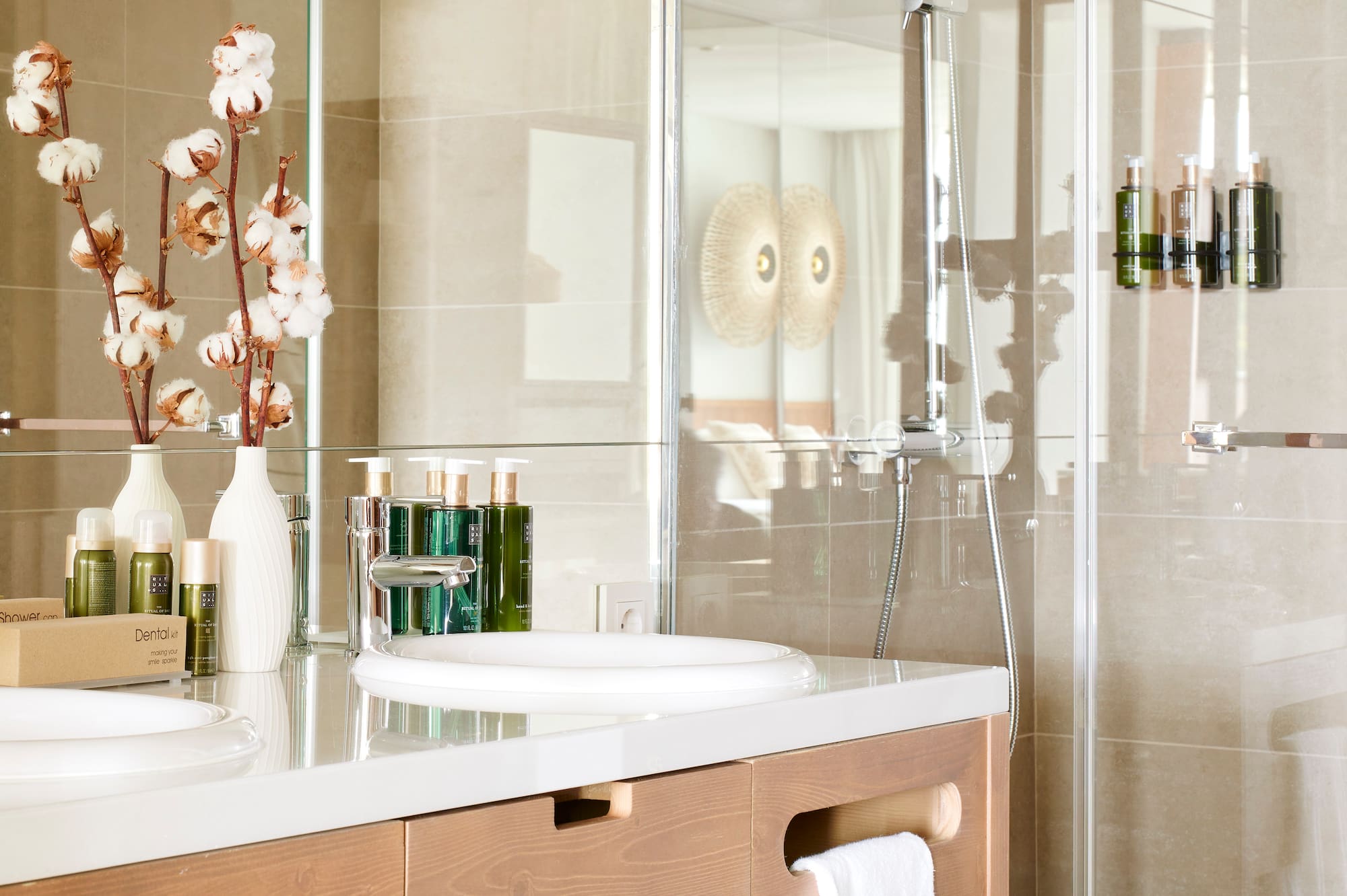 a bathroom with a glass shower and sink