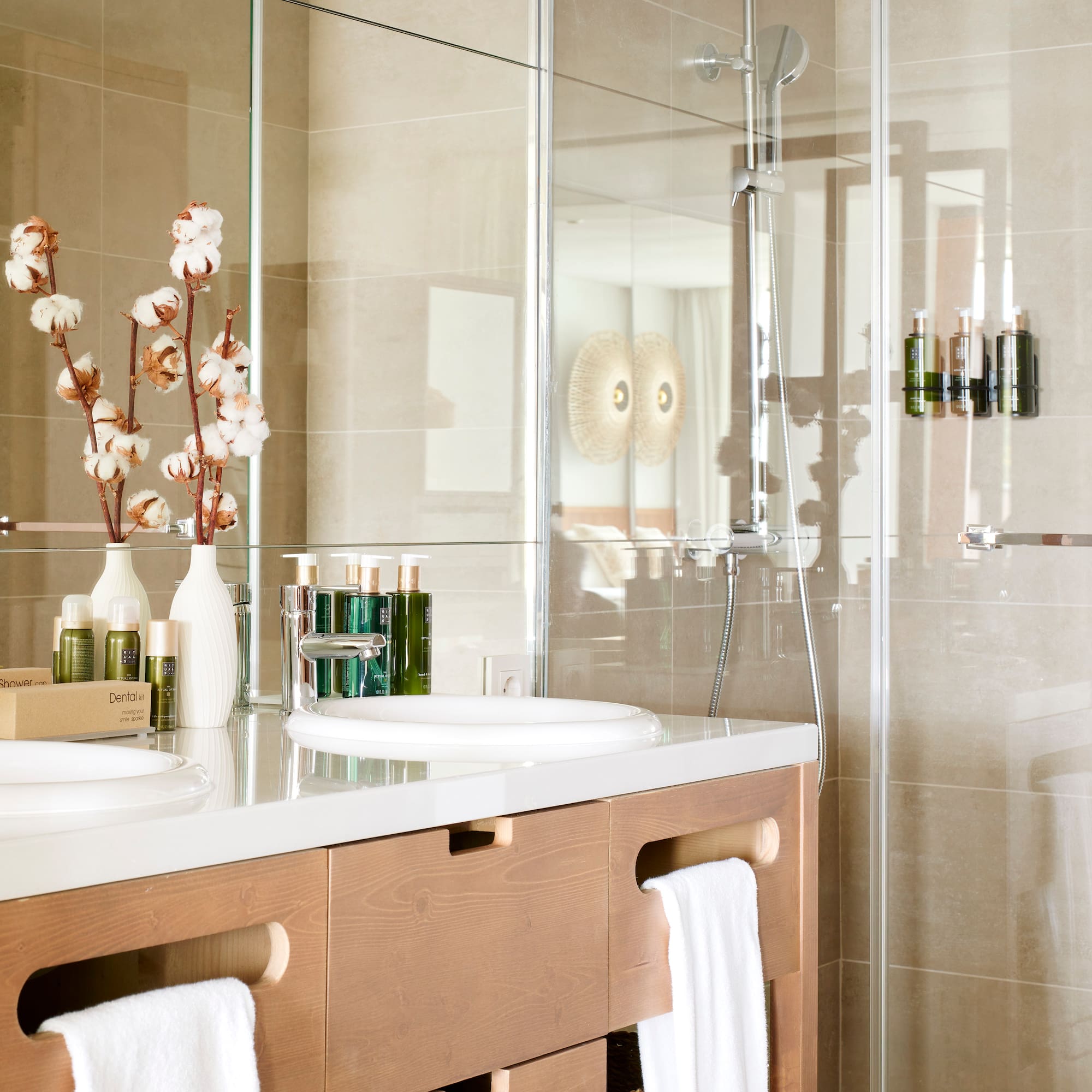 a bathroom with a glass shower and sink