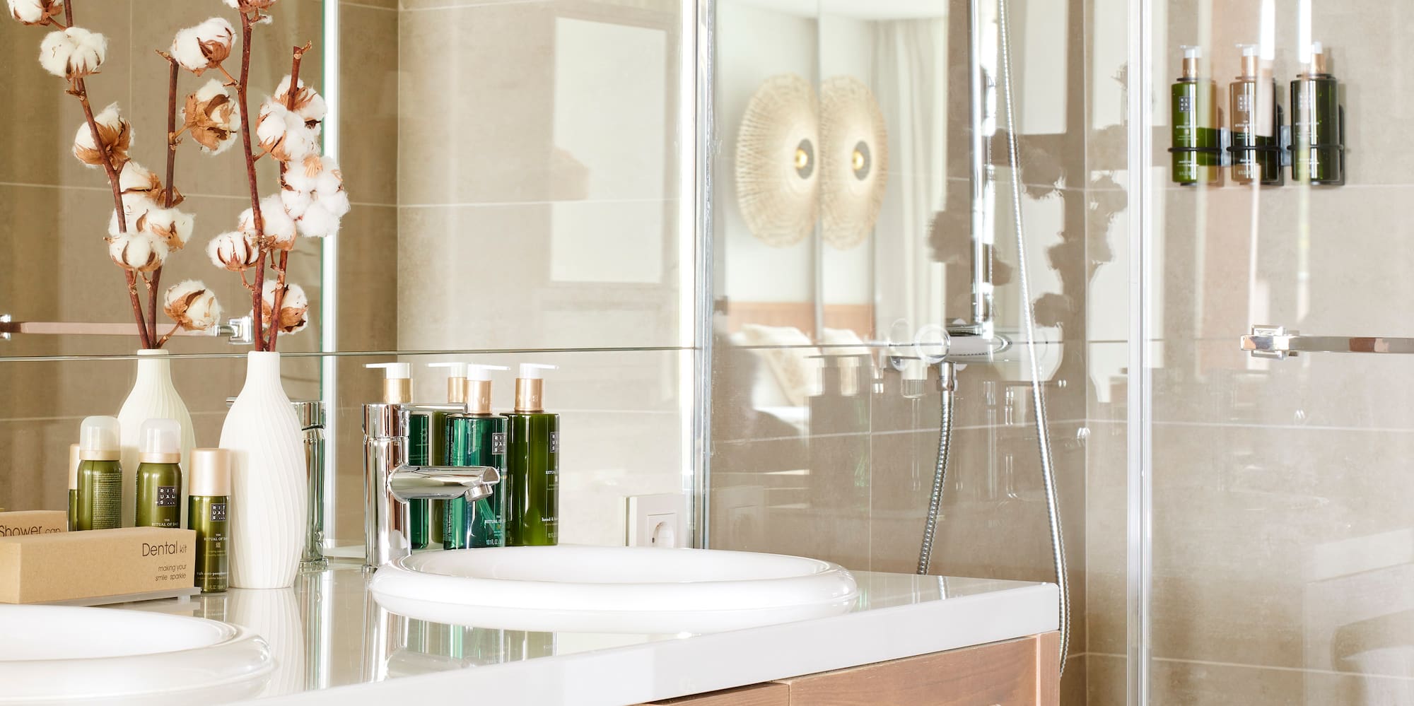 a bathroom with a glass shower and sink