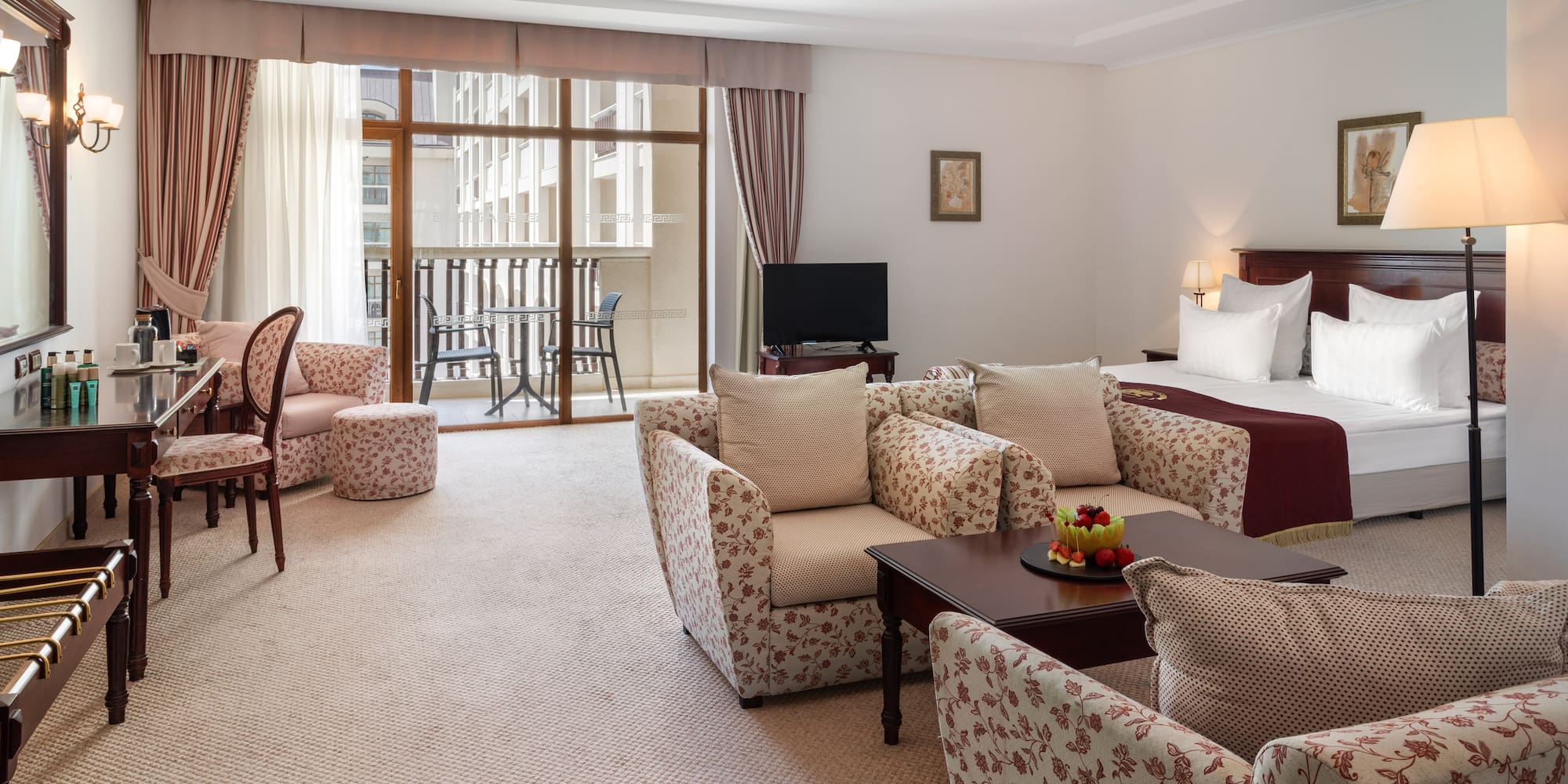 a room with a bed and chairs