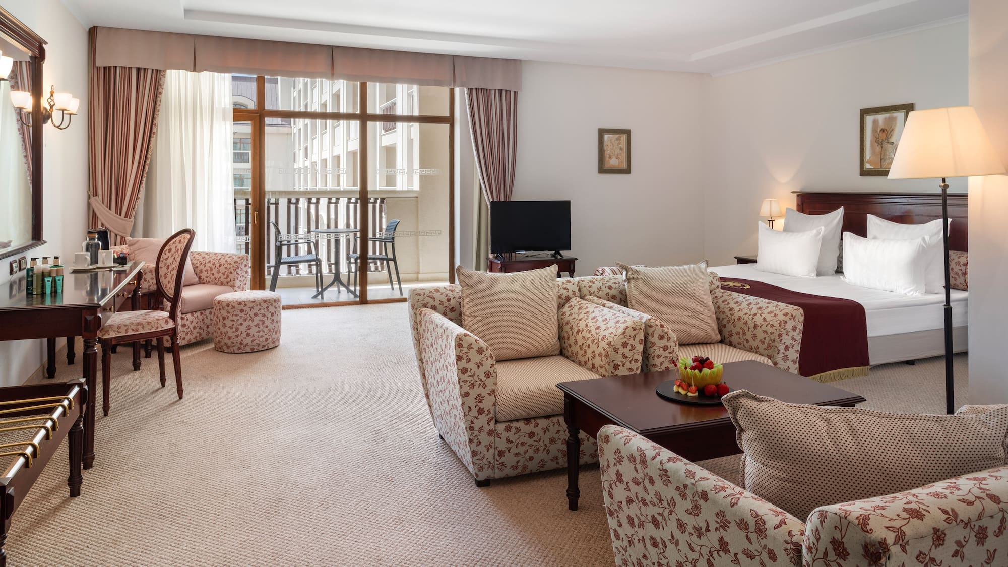 a room with a bed and chairs