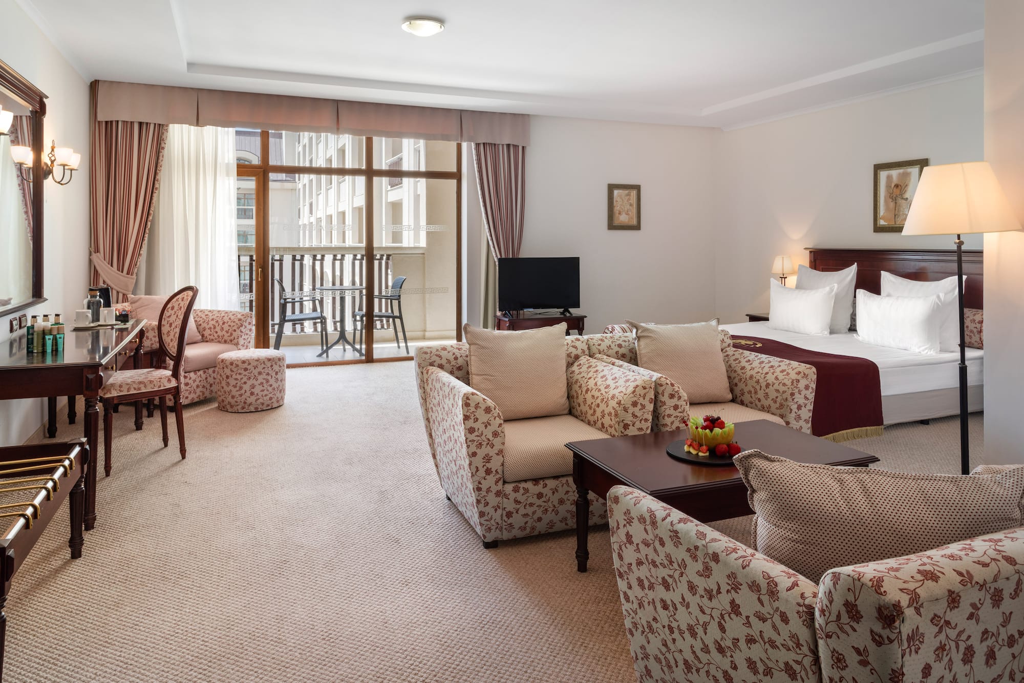 a room with a bed and chairs