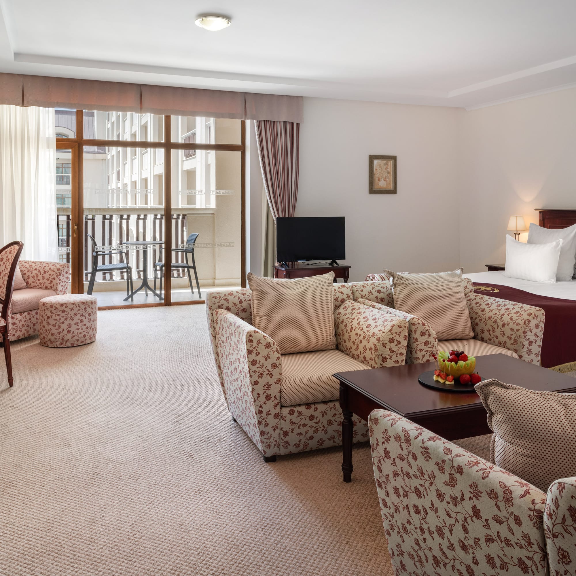 a room with a bed and chairs