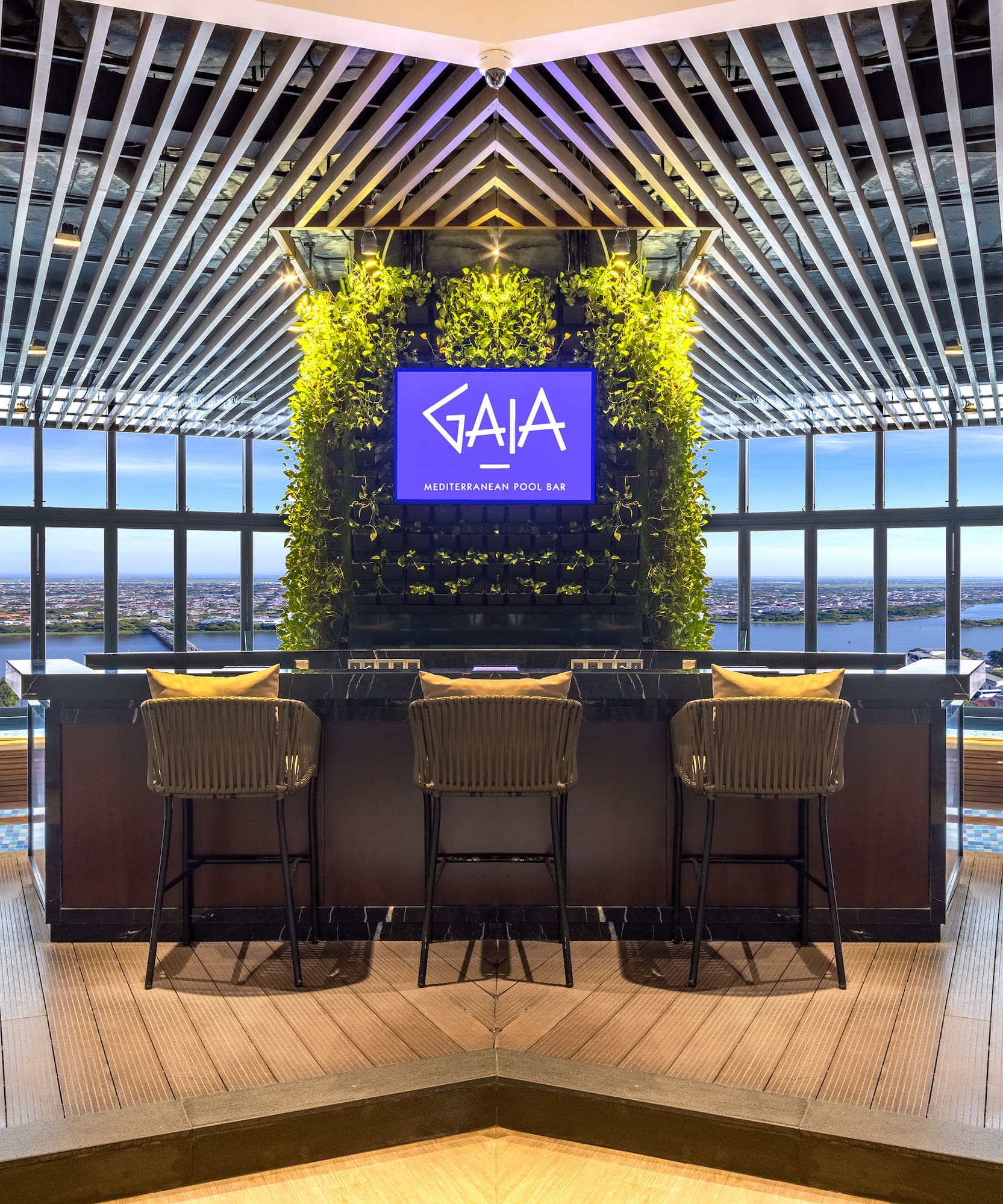 a bar with chairs and a tv in the middle