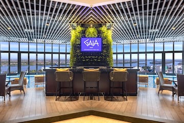 a bar with chairs and a tv in the middle