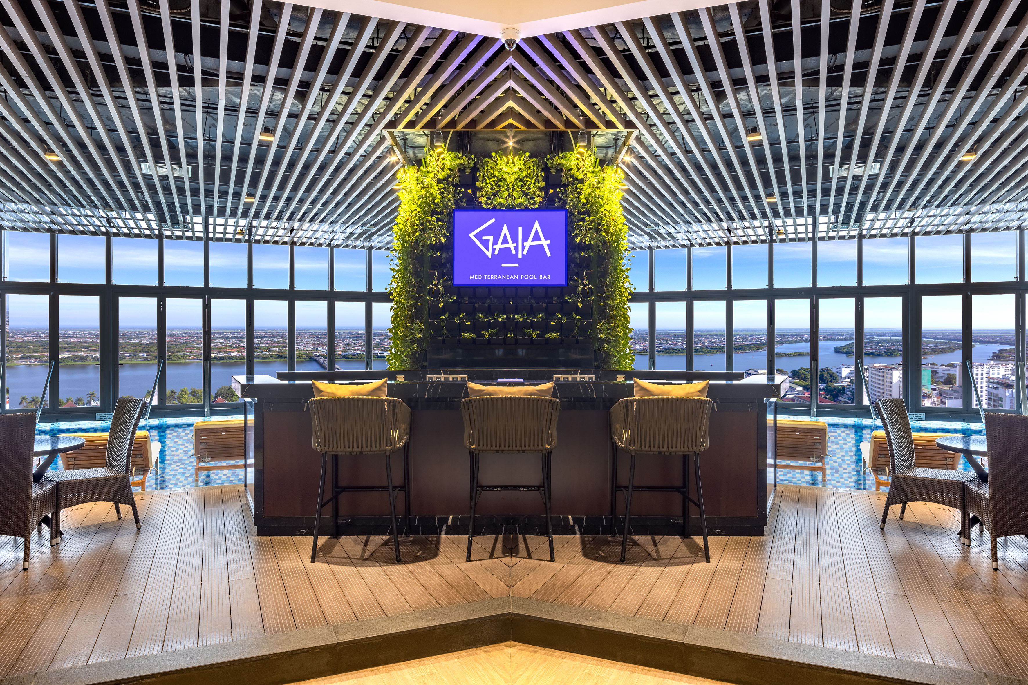 Gaia Mediterranean Pool Bar, green wall, city view, pool deck, modern design.