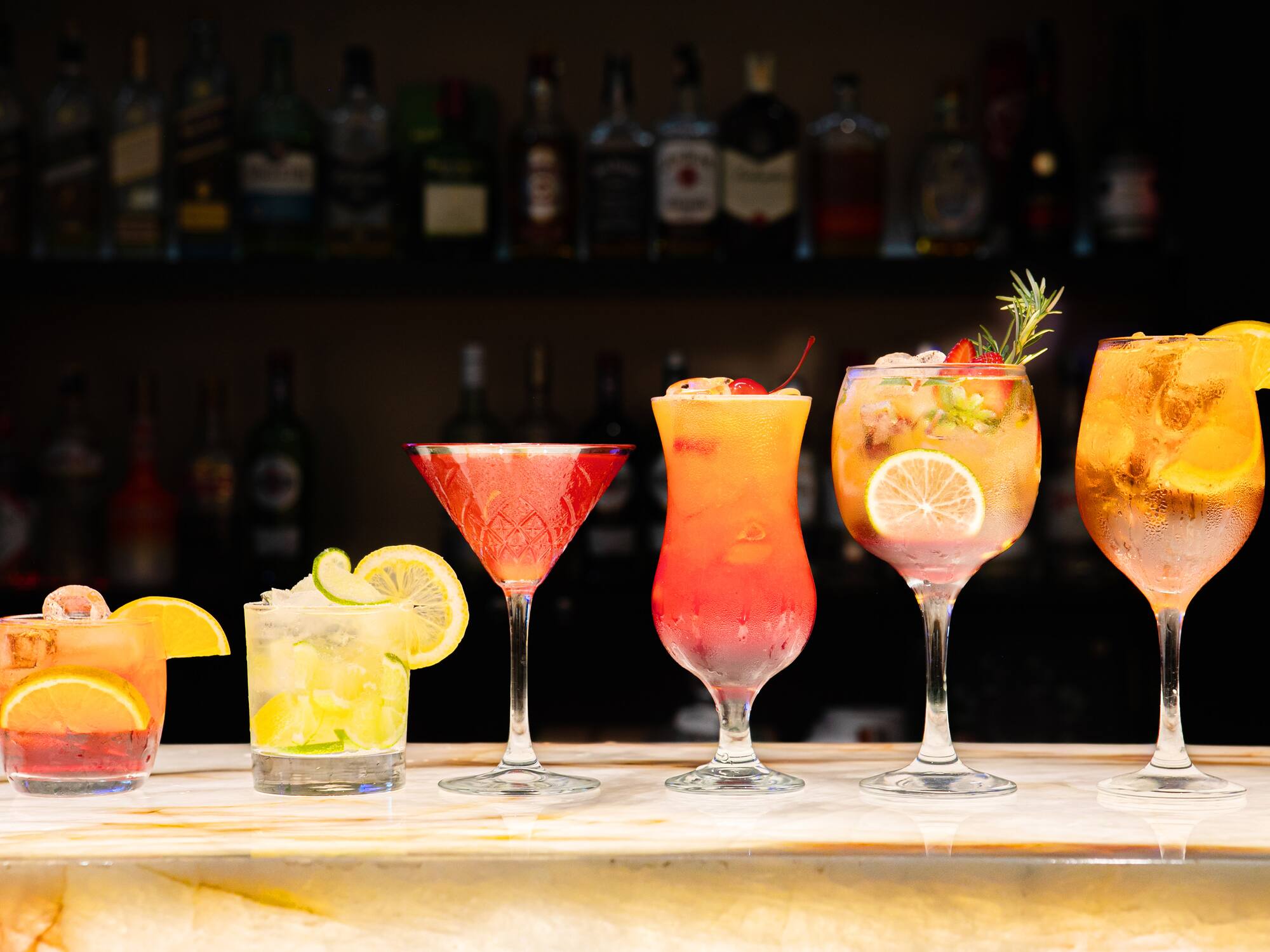 a row of different colored drinks
