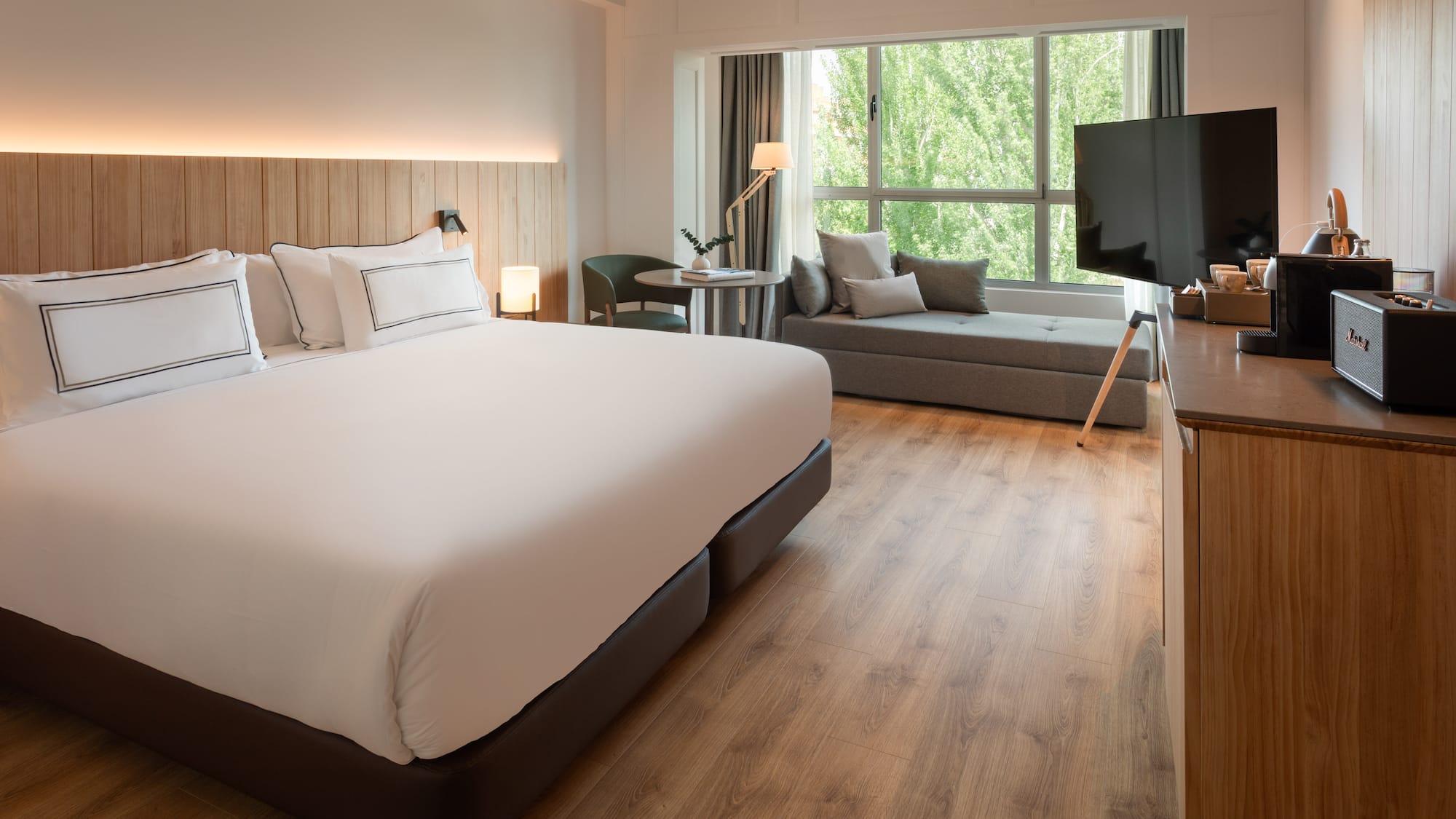 a room with a bed and a television