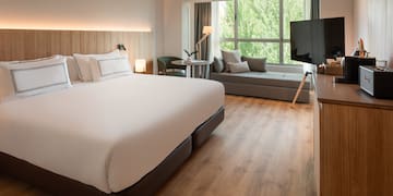 a room with a bed and a television