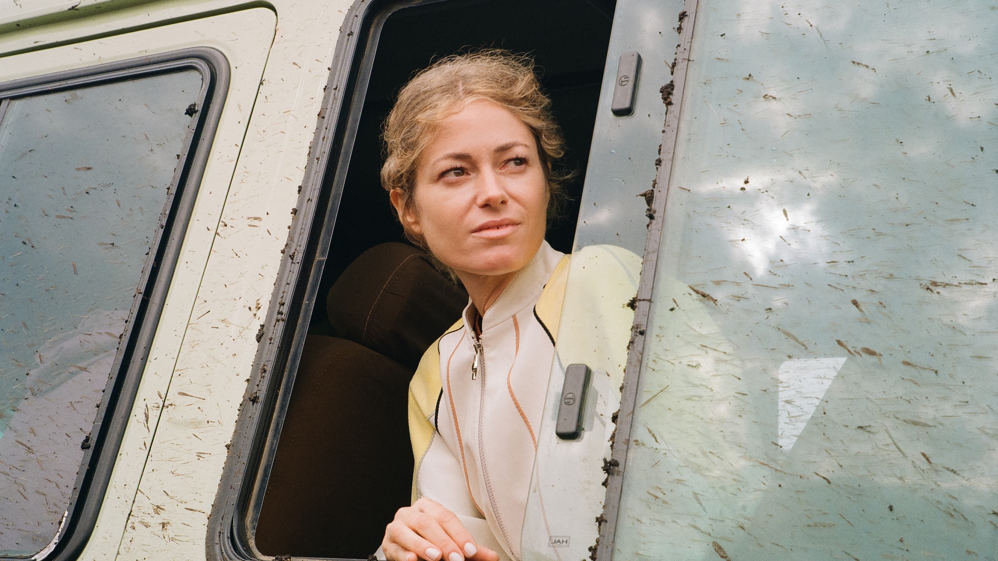 a woman looking out of a window of a van