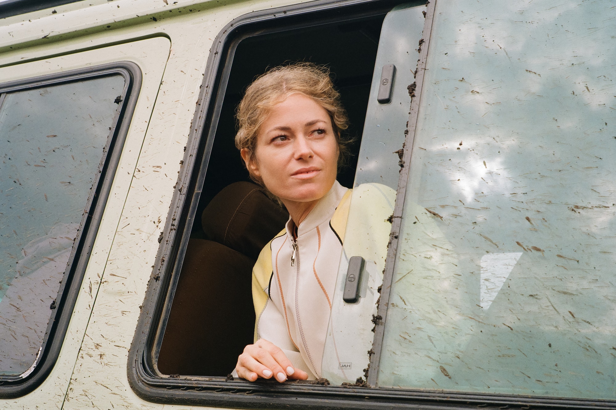 a woman looking out of a window of a van