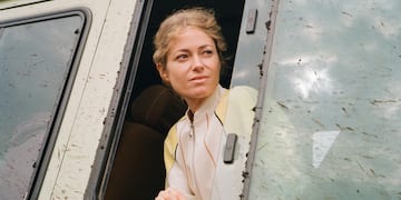 a woman looking out of a window of a van