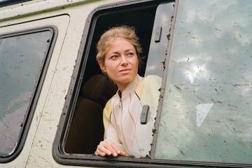 a woman looking out of a window of a van