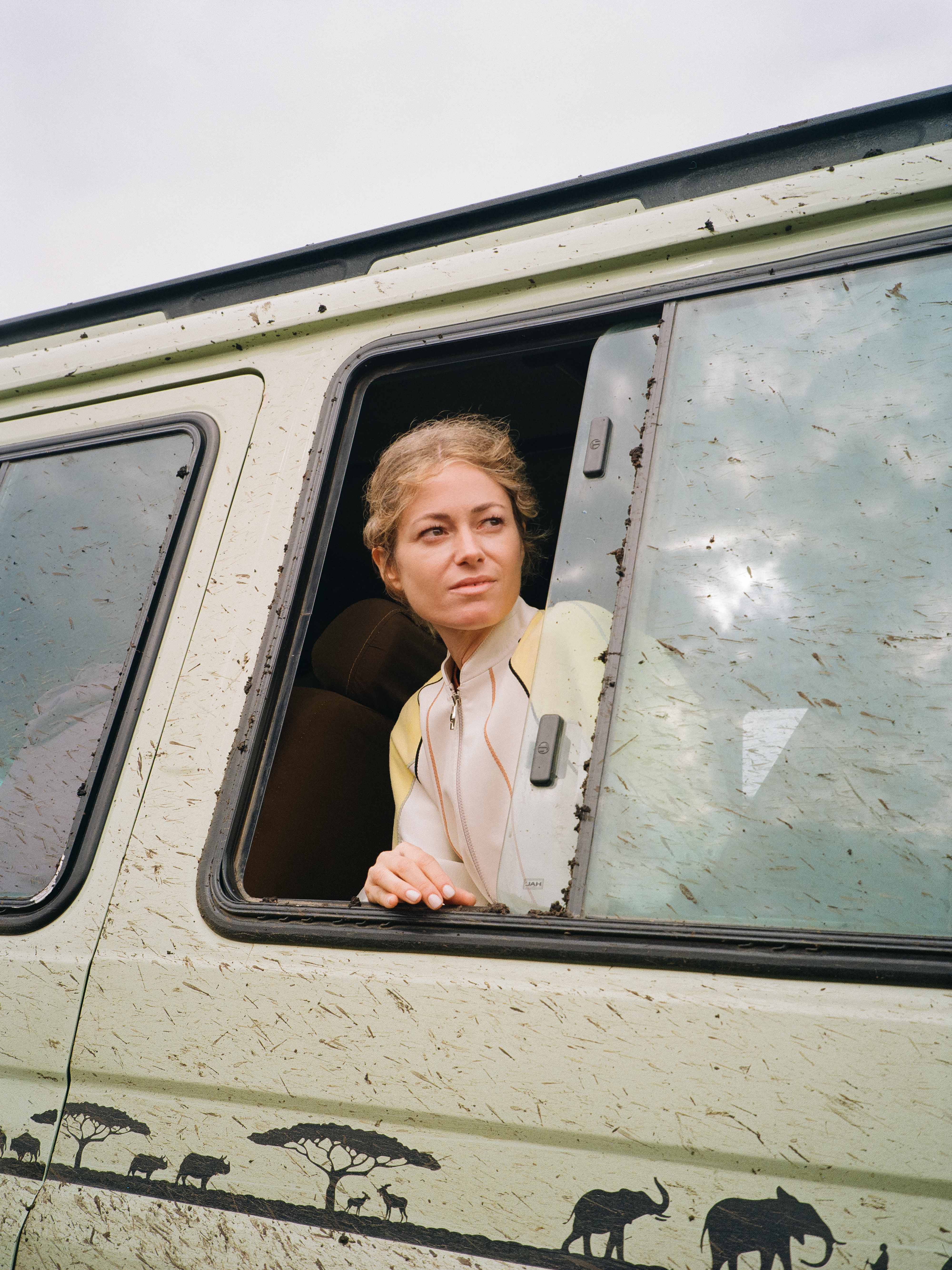 a woman looking out of a window of a van