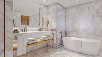 a bathroom with marble walls and a tub