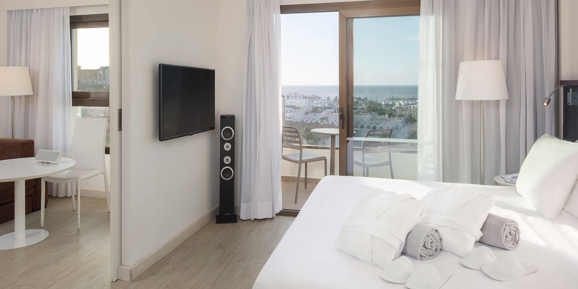 a bedroom with a television and a bed