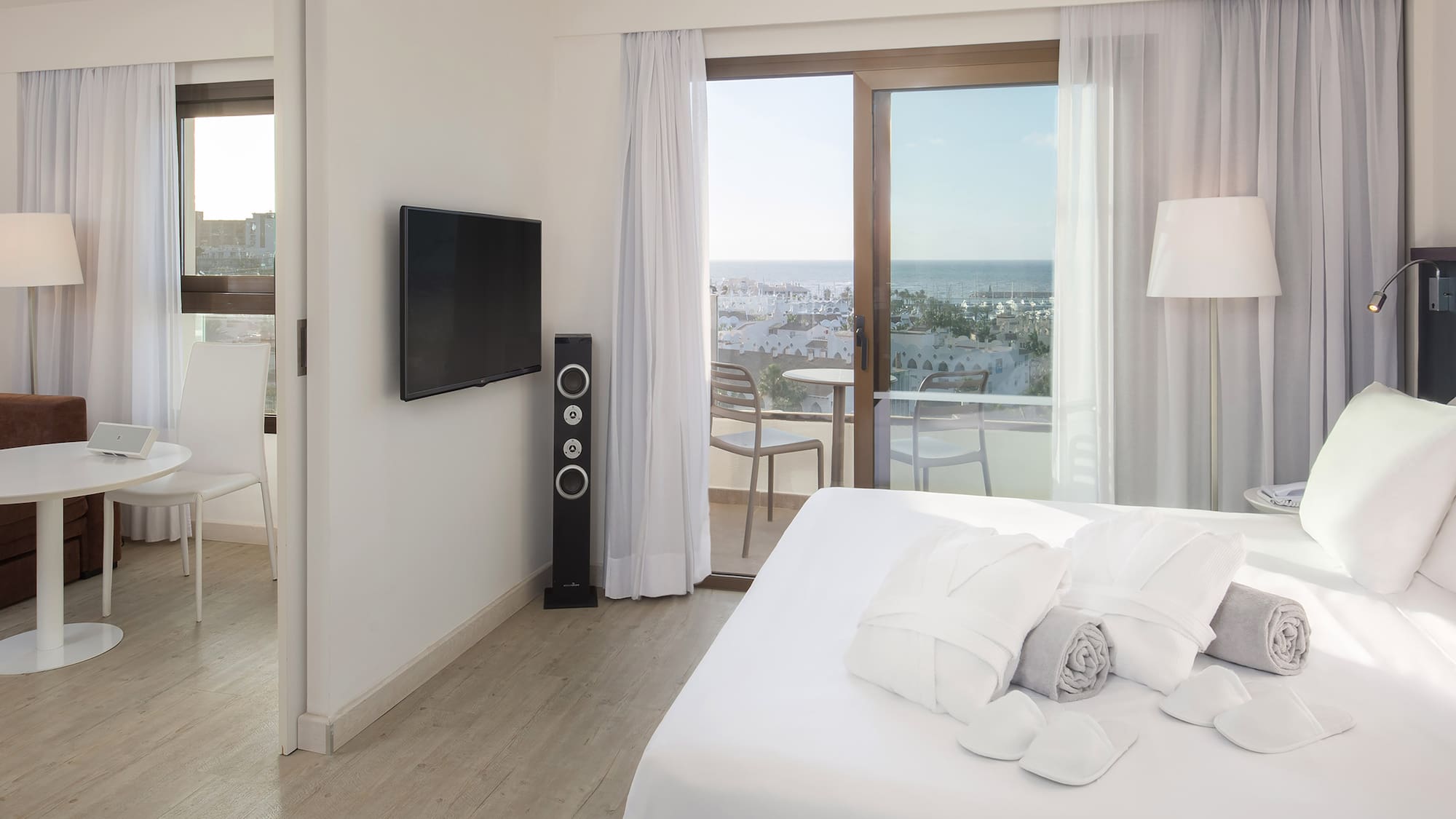 a bedroom with a television and a bed