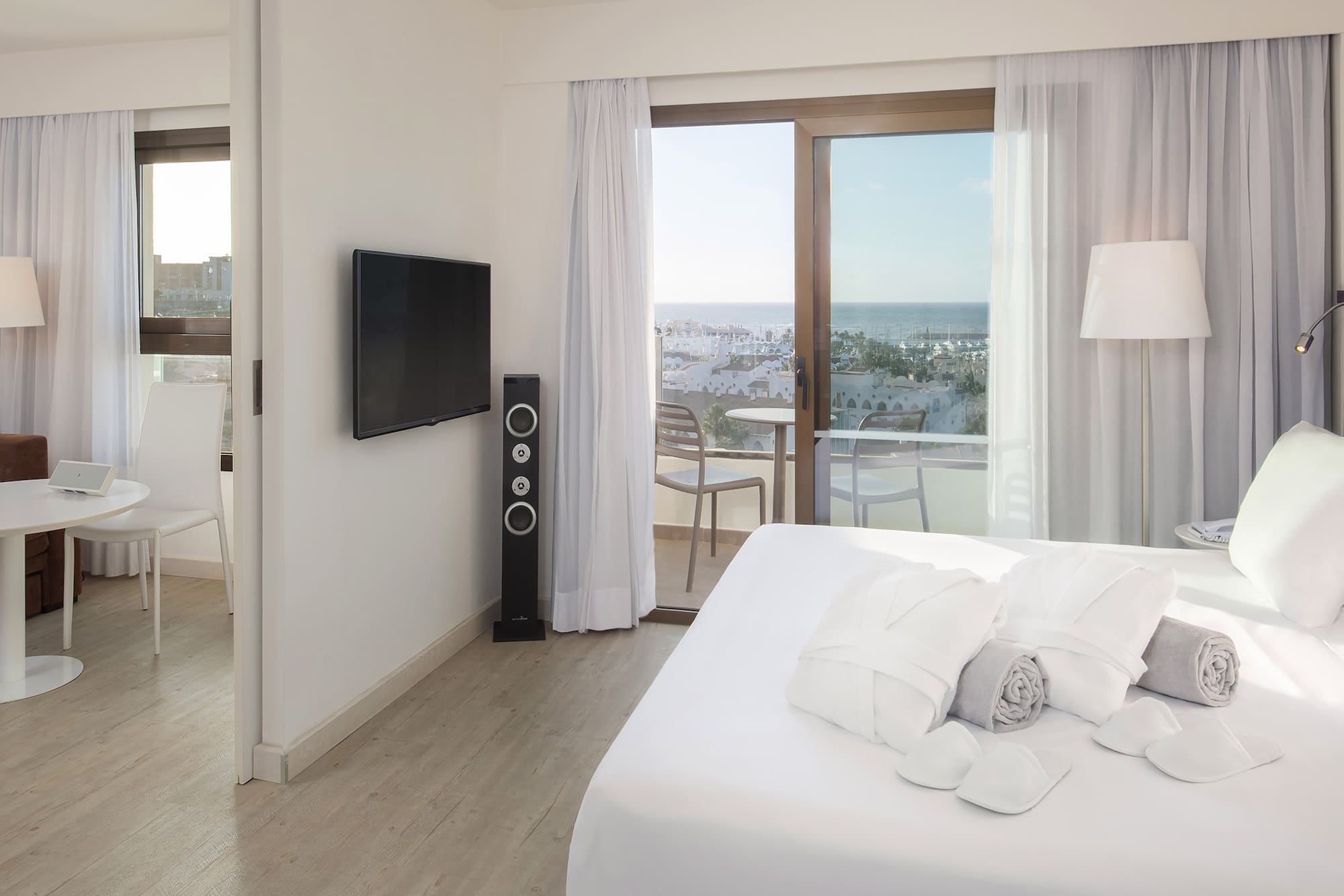 a bedroom with a television and a bed