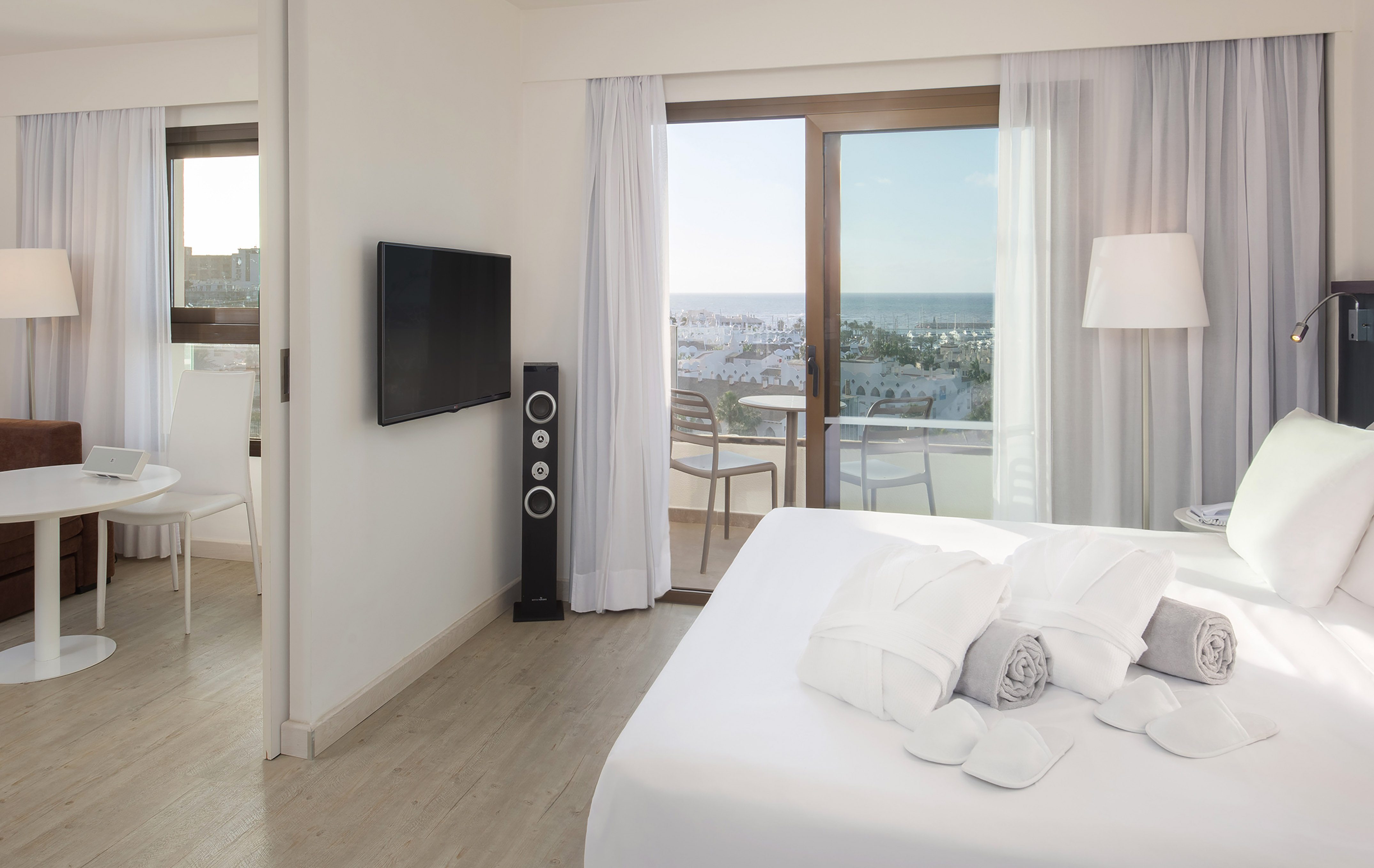 a bedroom with a television and a bed