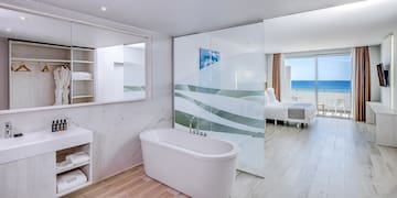 a bathroom with a bathtub and a mirror