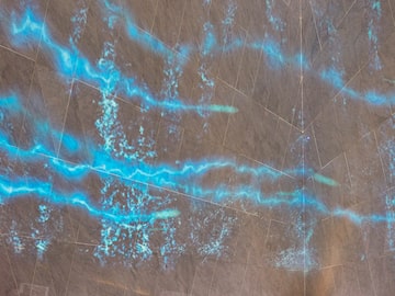 a blue light streaks on a wall