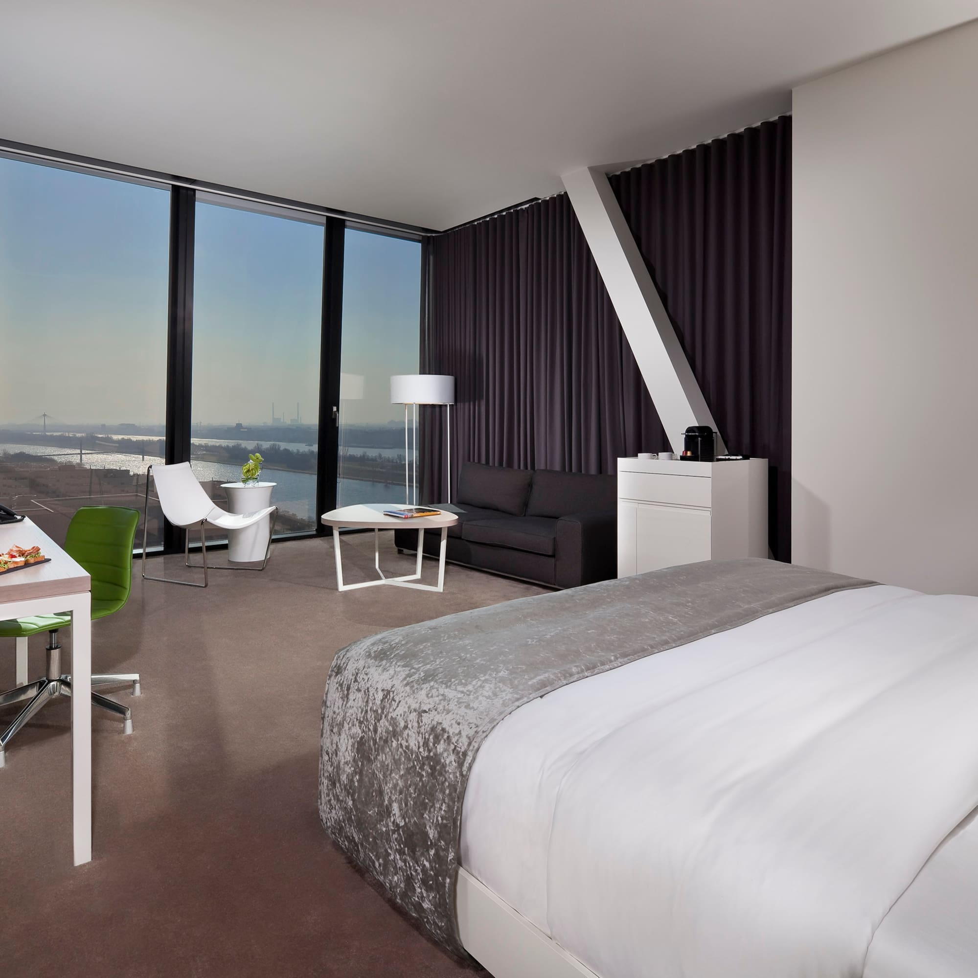 a room with a bed and a table and chairs