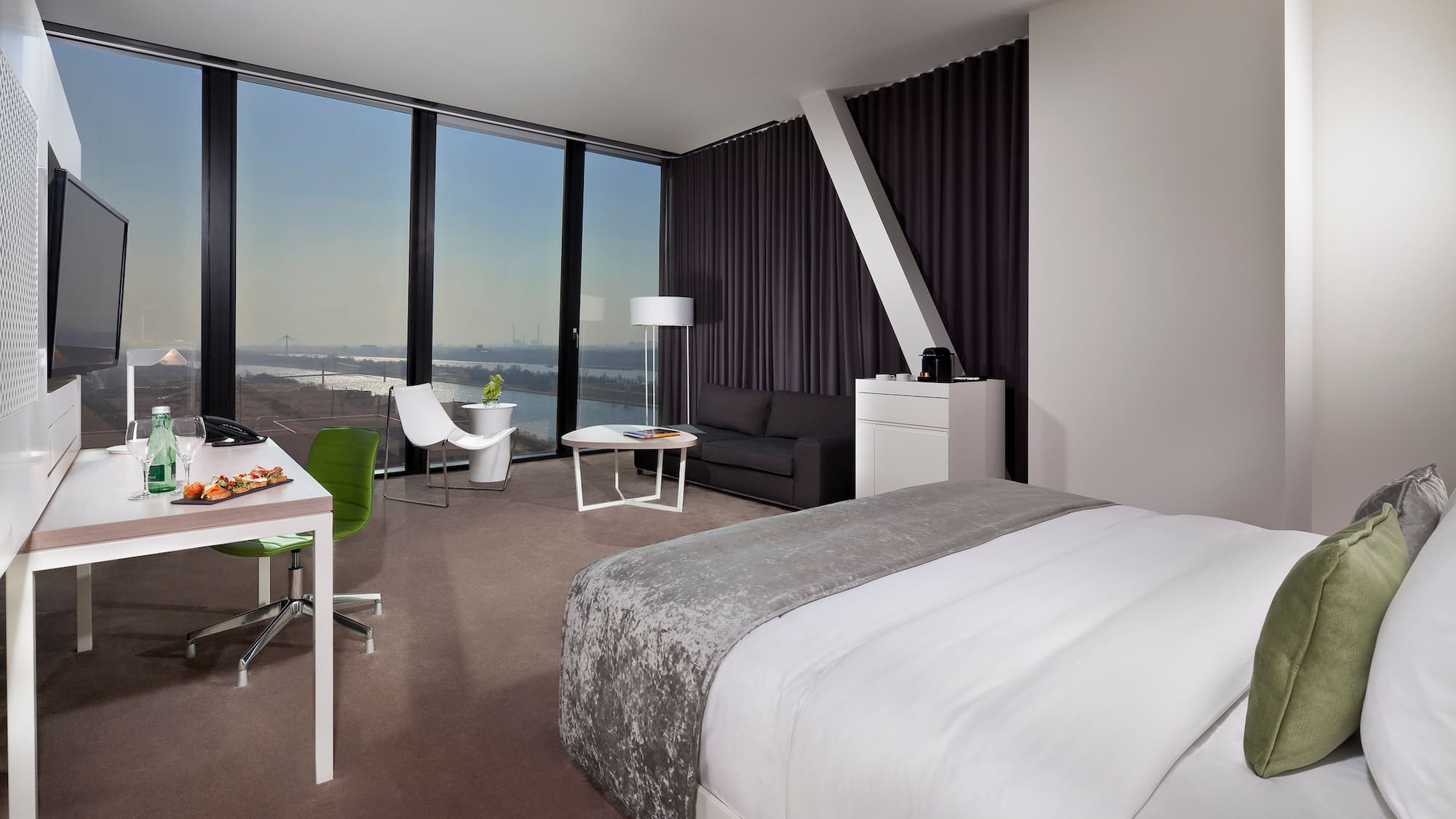 a room with a bed and a table and chairs