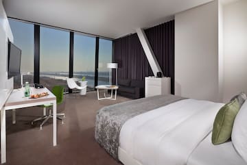 a room with a bed and a table and chairs