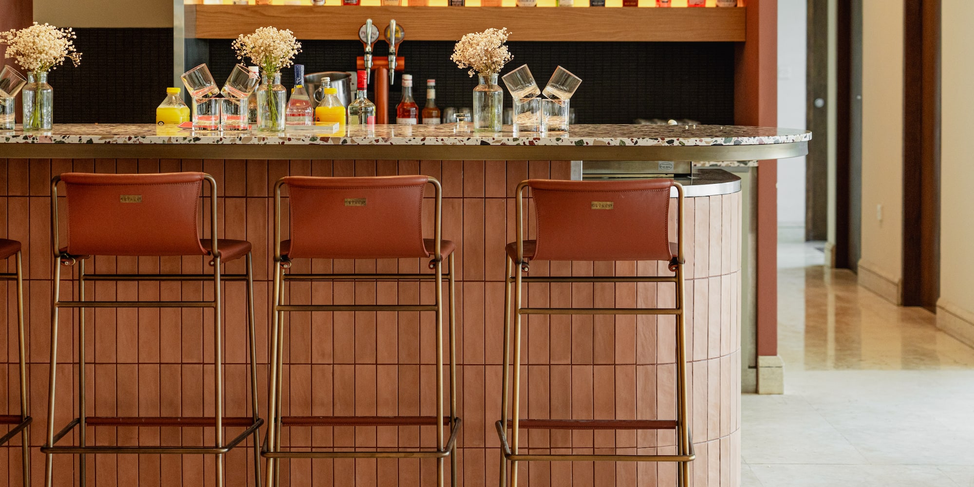 a bar with bottles of alcohol on the counter