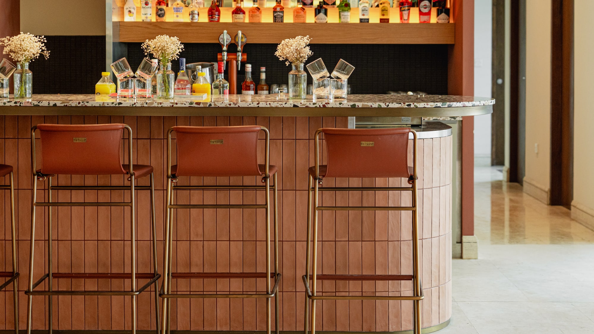 a bar with bottles of alcohol on the counter