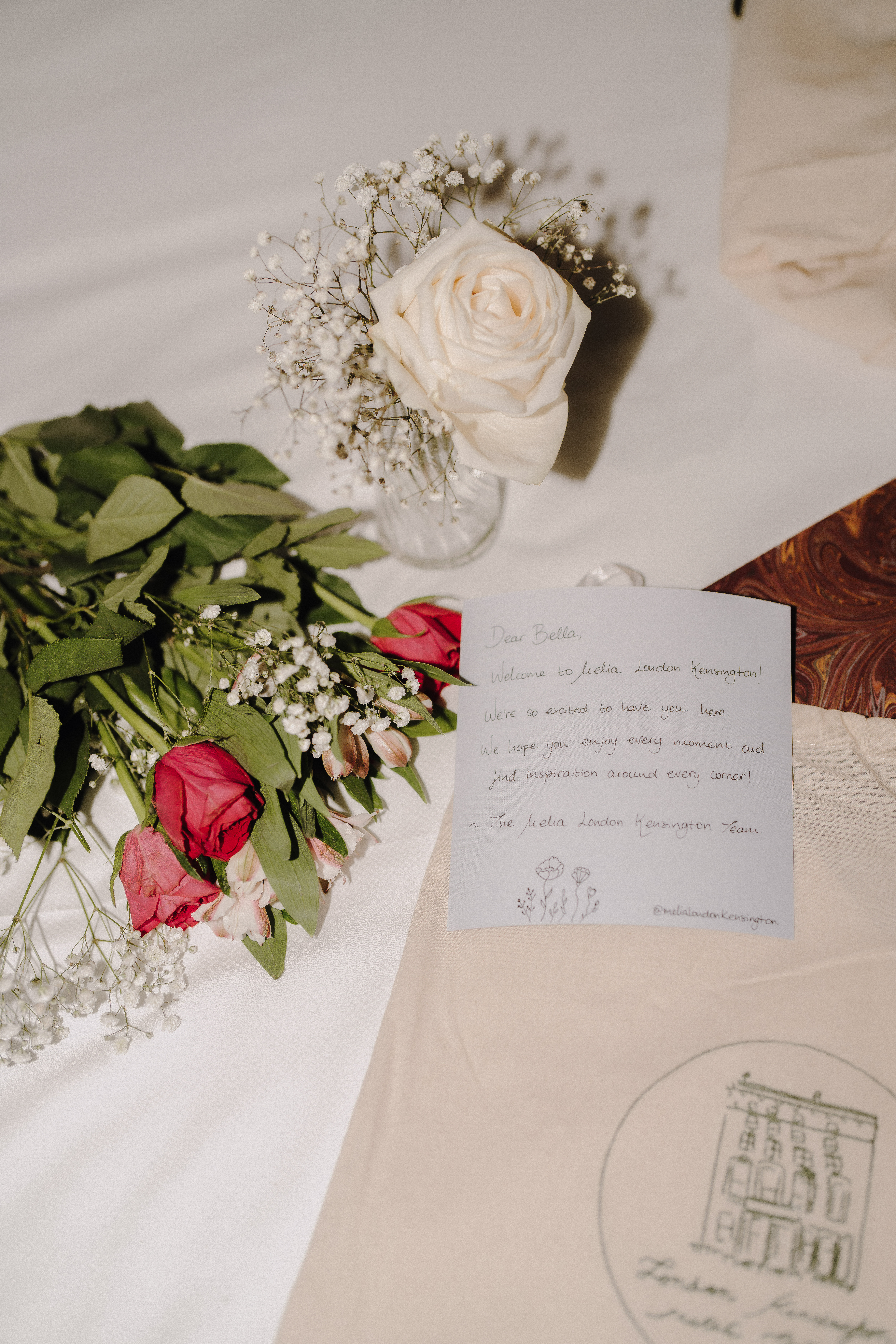a bouquet of roses and a note on a table