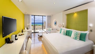a room with a bed and a table and chairs