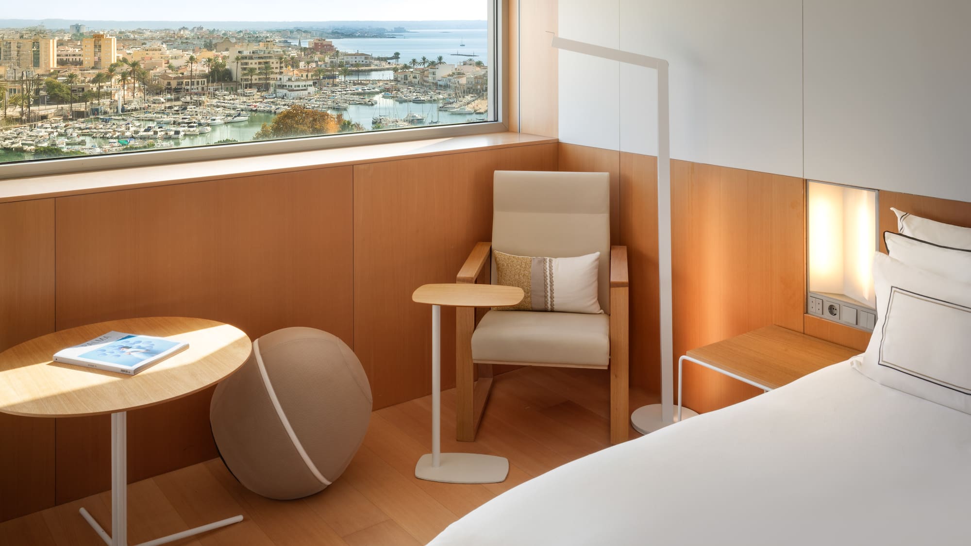 a room with a window and a chair and a table