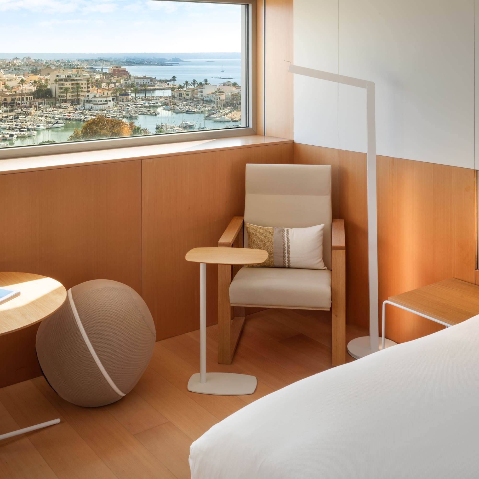 a room with a window and a chair and a table