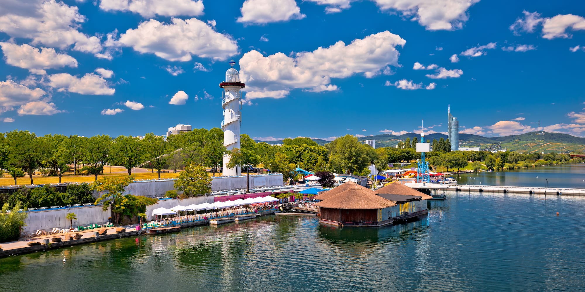 a water with a lighthouse and buildings