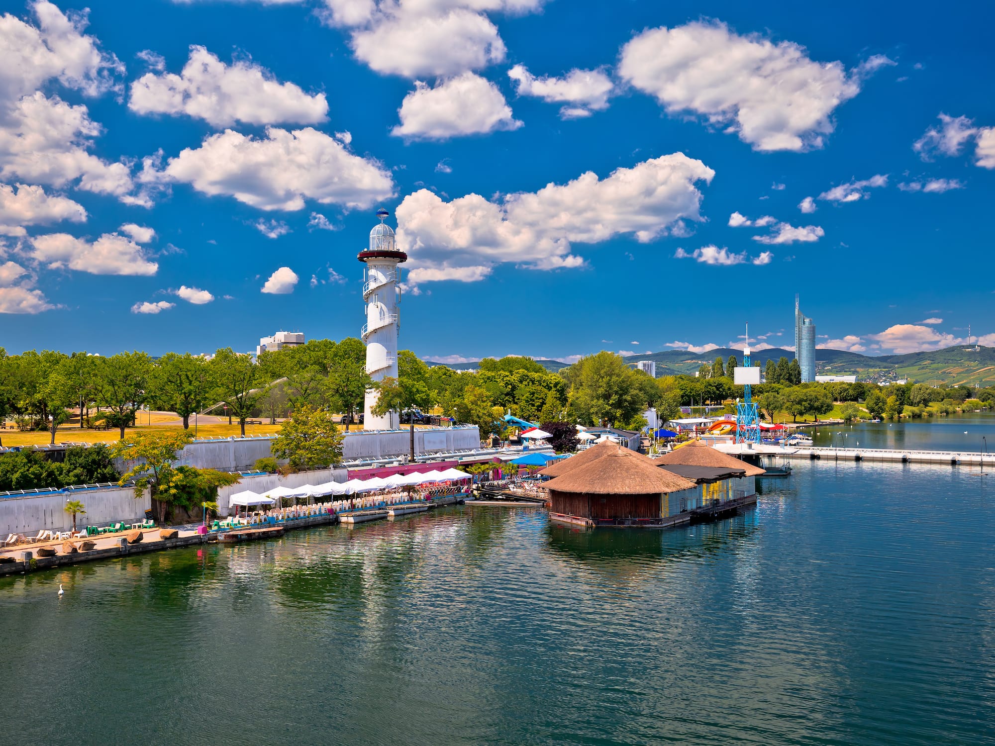 a water with a lighthouse and buildings