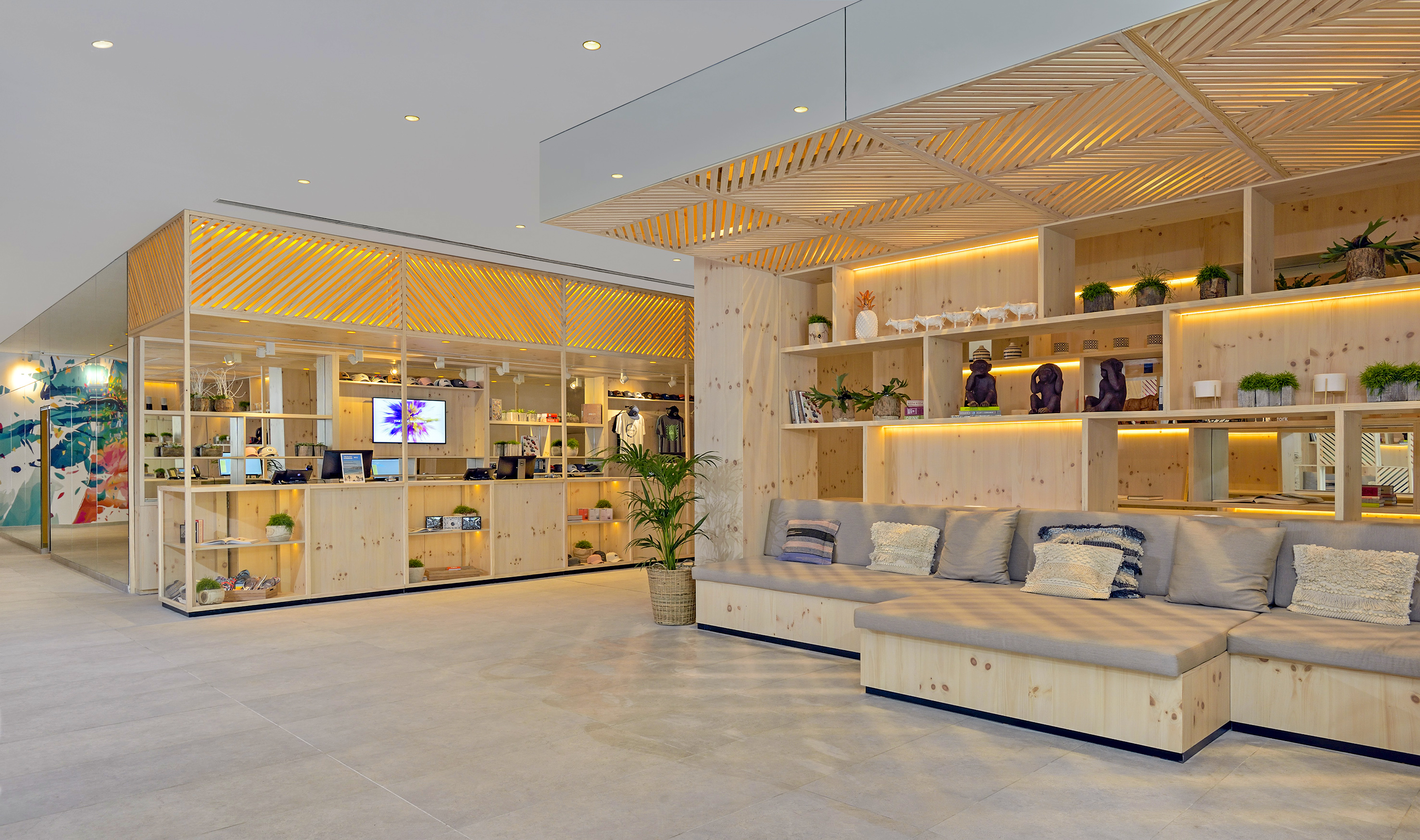 Natural wood retail and lounge, modern shelving, illuminated displays, and seating.