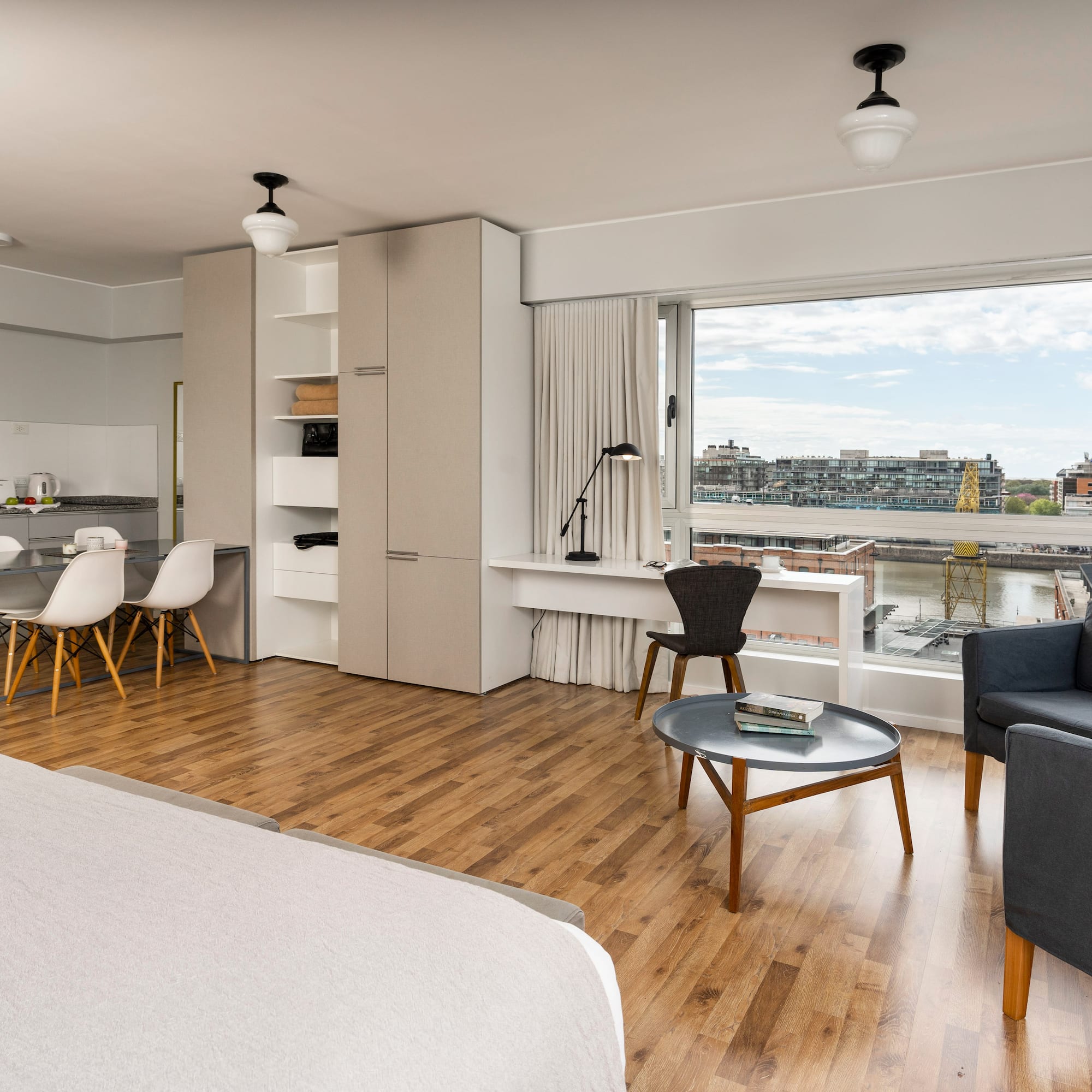 a room with a bed and a table and chairs