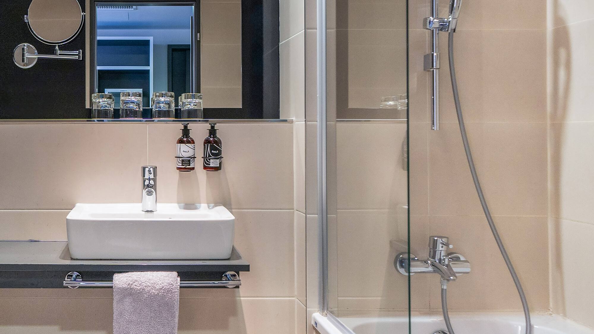 a bathroom with a shower and sink