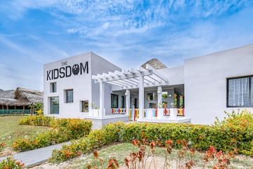 a building with a pergola and flowers