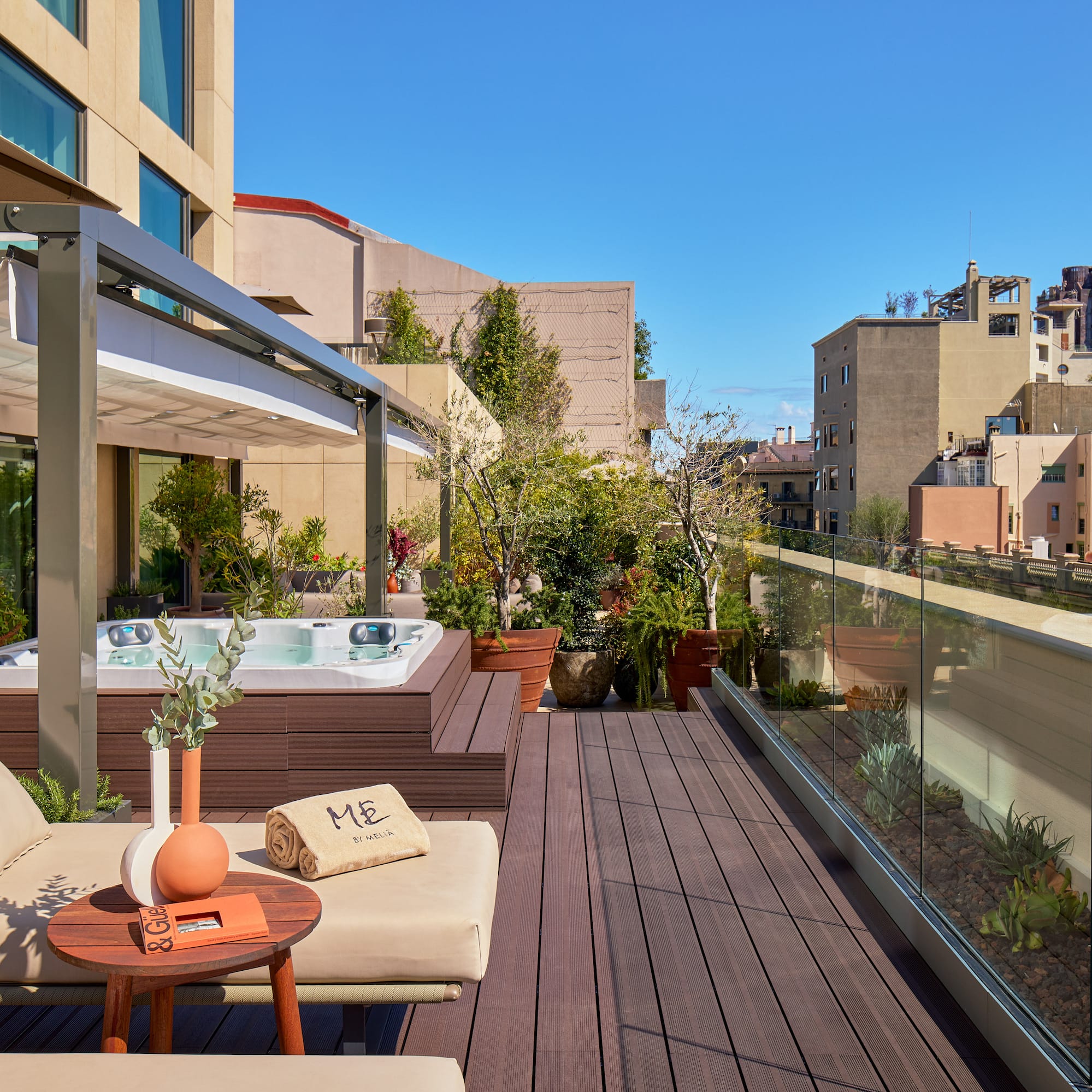 a patio with a hot tub and a table