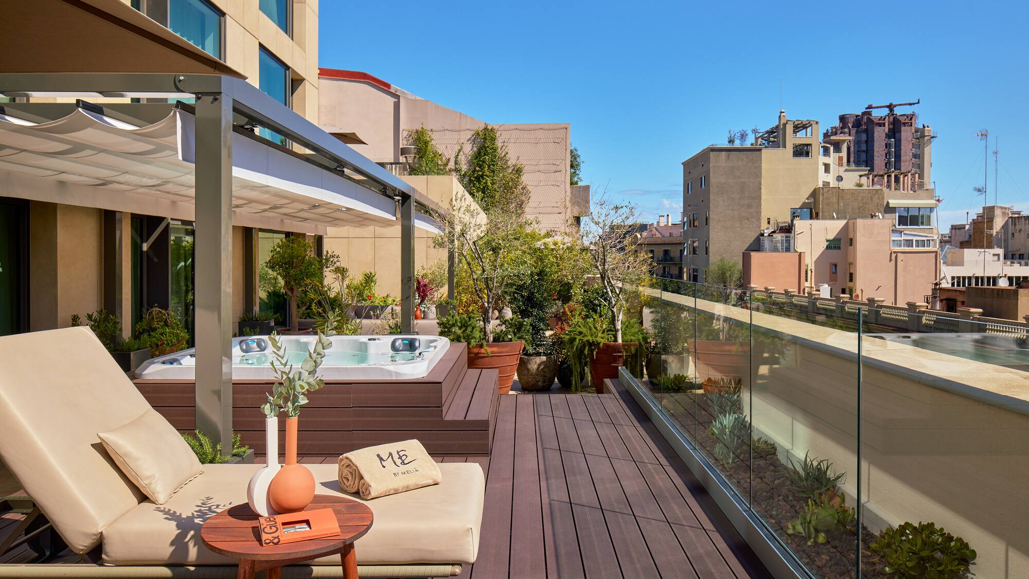 a patio with a hot tub and a table