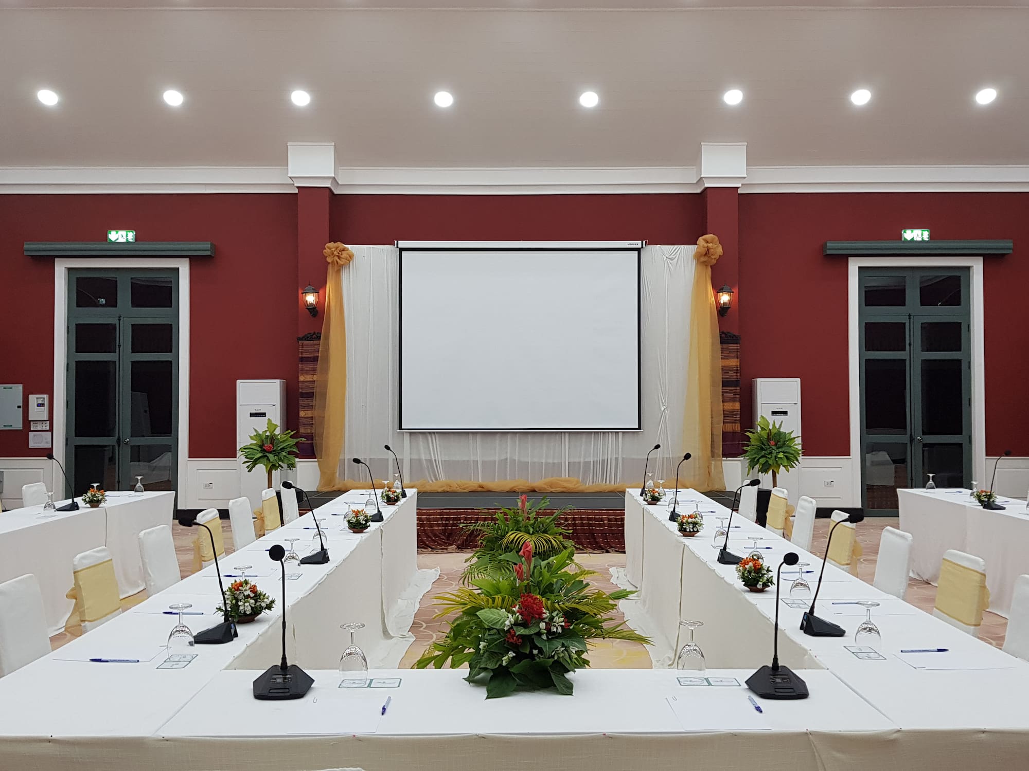 a room with long tables and chairs