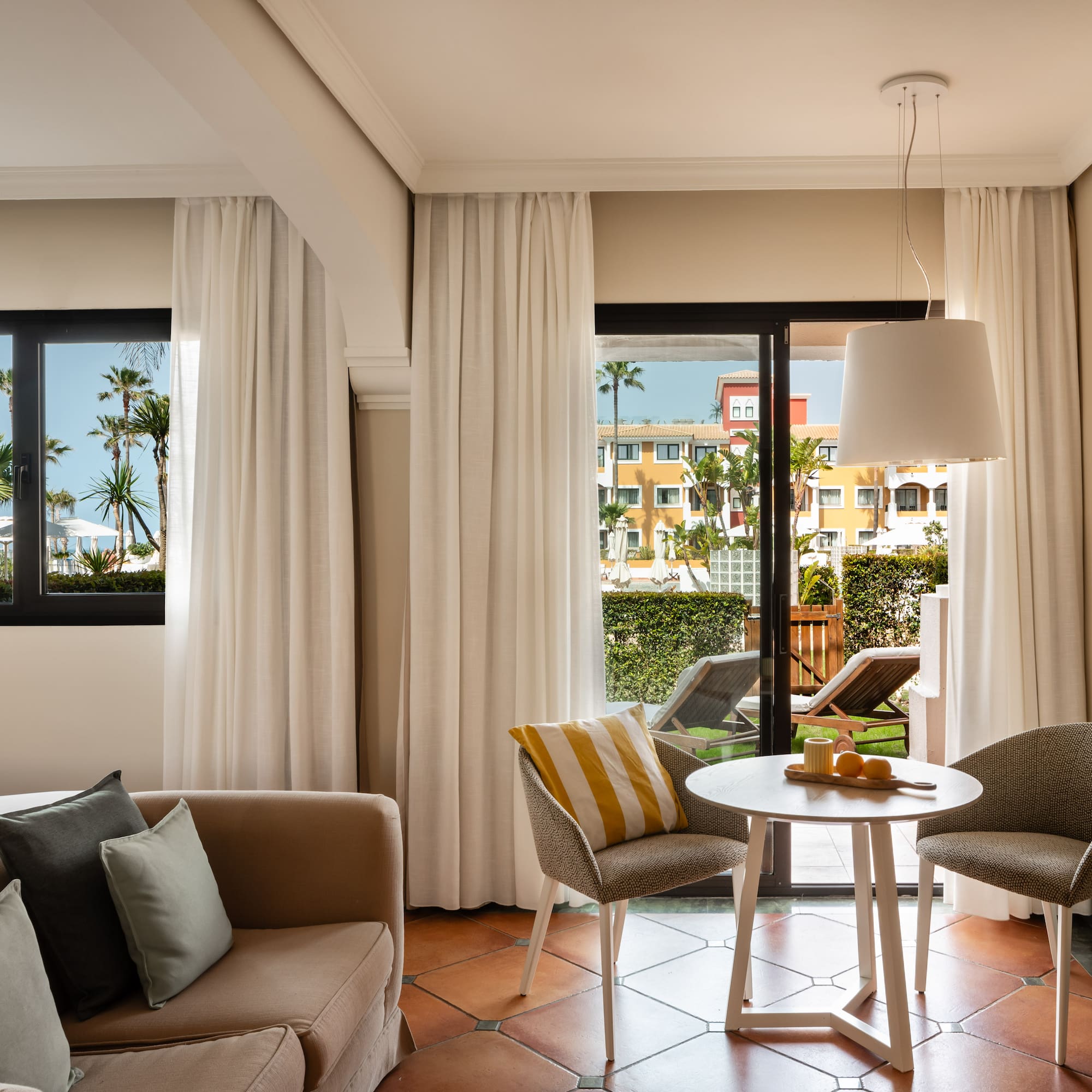 a living room with a couch and chairs