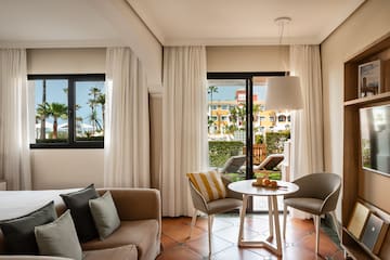 a living room with a couch and chairs