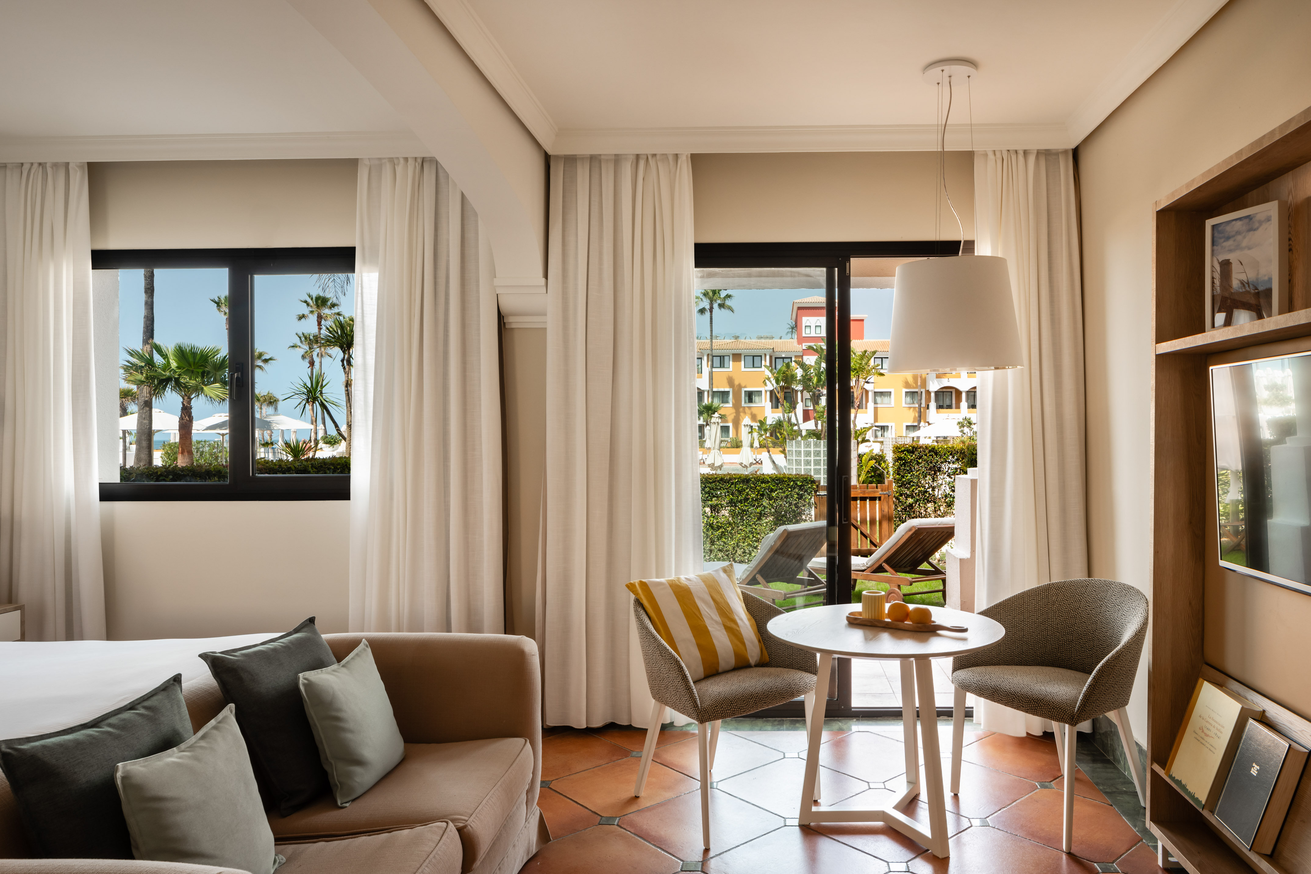 a living room with a couch and chairs