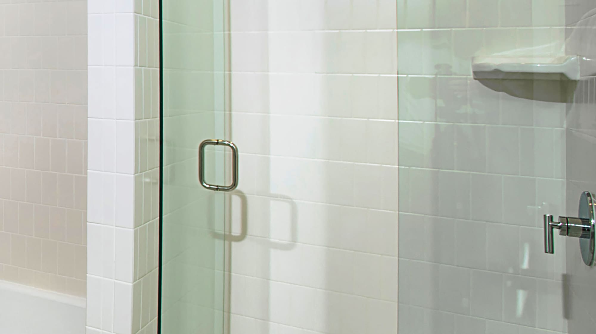 a glass shower door in a bathroom