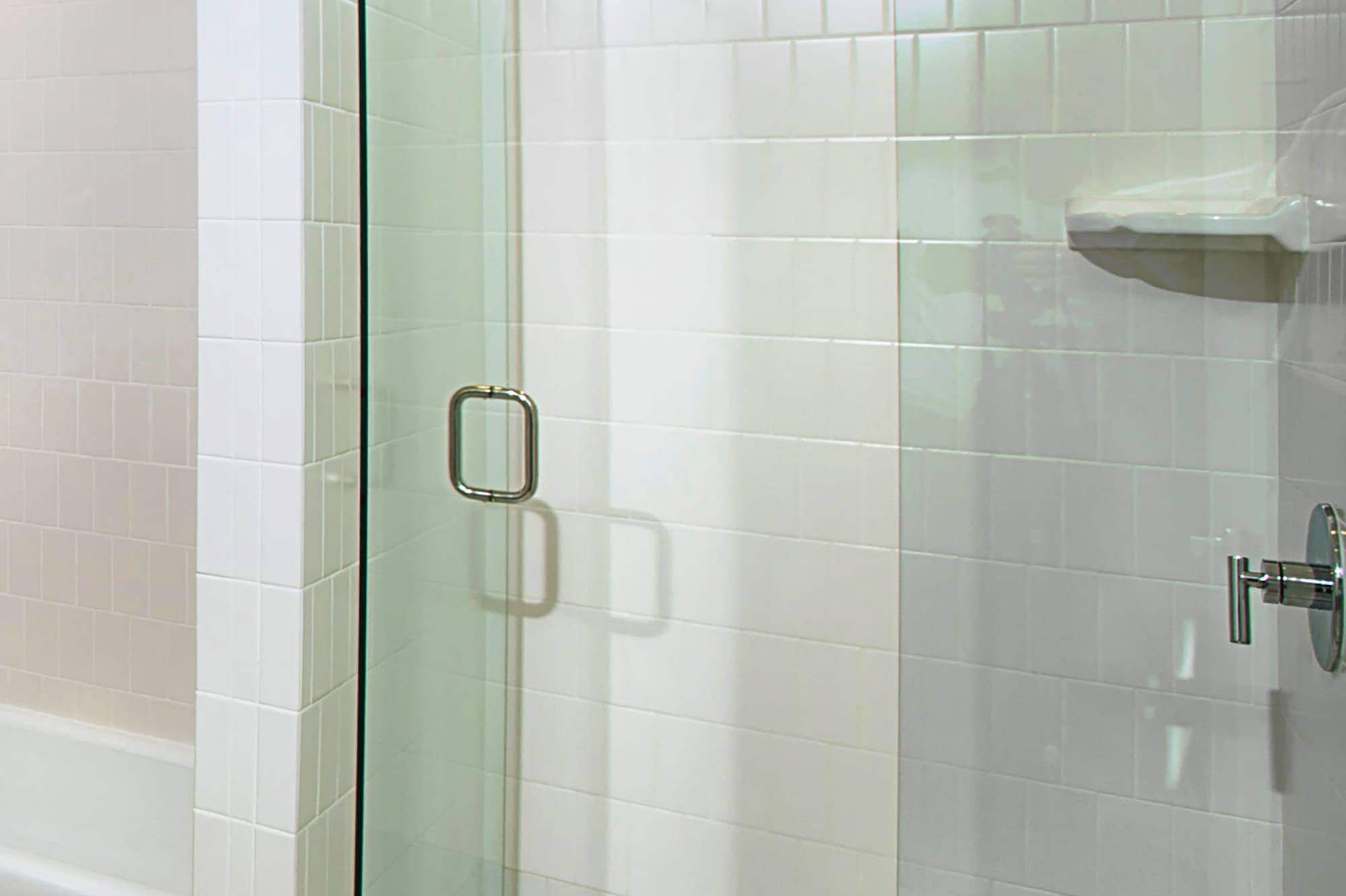 a glass shower door in a bathroom