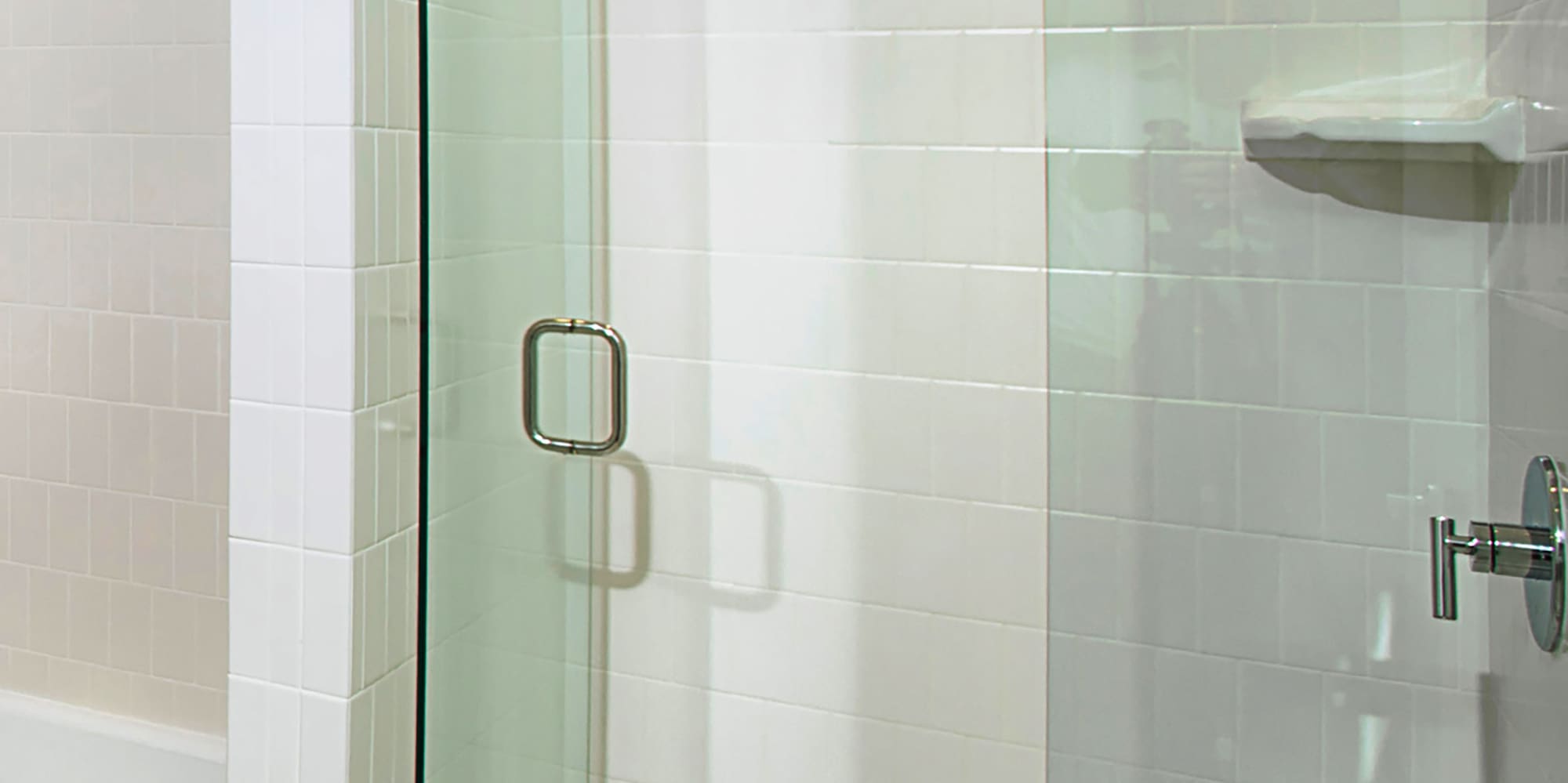 a glass shower door in a bathroom