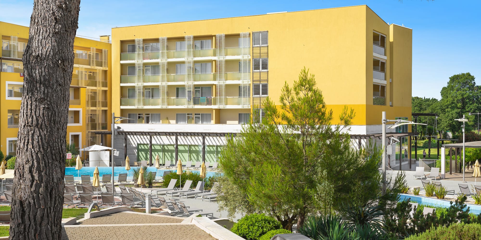 a building with a pool and trees